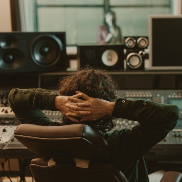 sound producer relaxing in armchair at recording studio